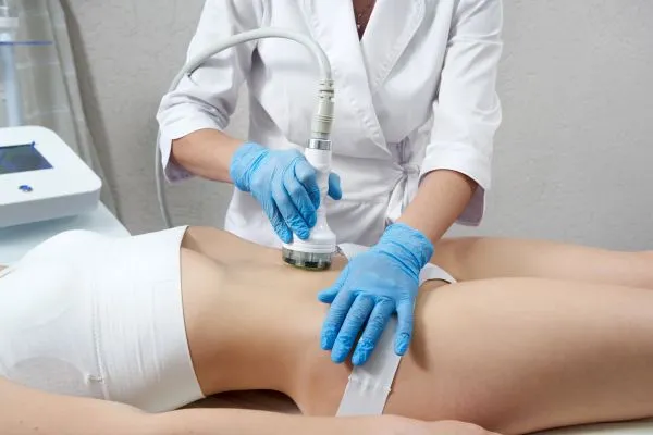 Lost the Weight but Not the Loose Skin? 2 woman having HIFU treatment on her stomach to combat loose skin Twickenham following weight loss